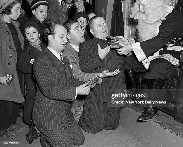 The Three Stooges, who won stage fame with Ted Healy, who died mysteriously yesterday, make a grim demand on department store Santa. The Three...