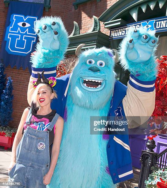 In this handout photo provided by Disney Parks, Gwen Stefani meets Sulley from the Disney-Pixar films 'Monsters, Inc.' and 'Monsters University' at...