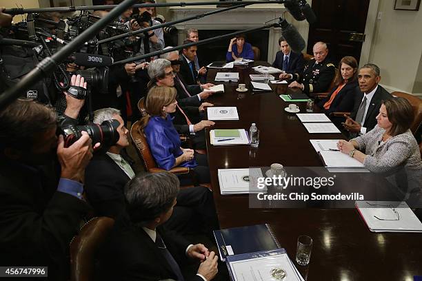 President Barack Obama talks to members of the news media after a meeting on the Ebola outbreak in West Africa with members of his cabinet and health...