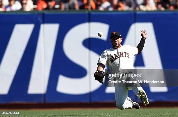 Gregor Blanco of the San Francisco Giants fails to get the out on a single by Anthony Rendon of the Washington Nationals in the first inning during...