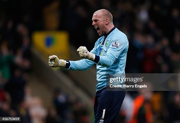 Norwich City goalkeeper John Ruddy celebrates after teammate Gary Hooper scored during the Premier League match between Norwich City and Swansea City...