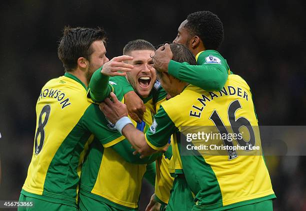 Gary Hooper of Norwich celebrates scoring their first goal with team mates during the Barclays Premier League match between Norwich City and Swansea...