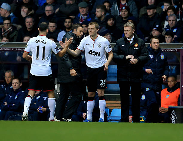 Darren Fletcher of Manchester United replaces Ryan Giggs as a substitute as David Moyes manager of Manchester United looks on during the Barclays...