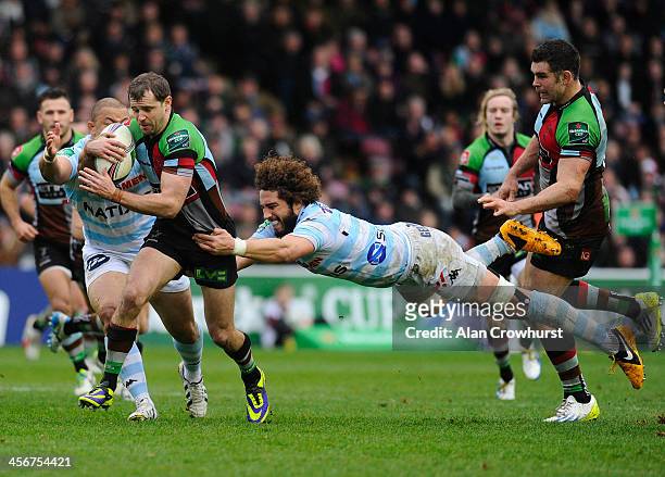 Nick Evans of Harlequins is tackled by Camille Gerondeau during the Heineken Cup Pool 4 round 4 match between Harlequins and Racing Metro 92 at The...