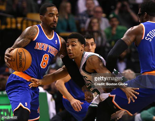 Boston Celtics point guard Phil Pressey fights through a pick set by New York Knicks power forward Amar'e Stoudemire as he defends New York Knicks...