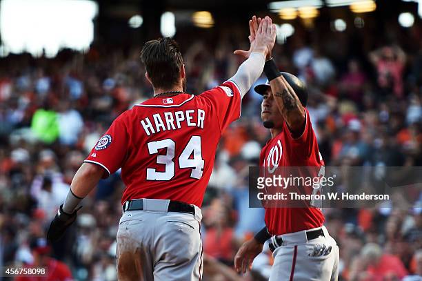 Bryce Harper and Ian Desmond of the Washington Nationals celebrate after they scored in the seventh inning against the San Francisco Giants during...