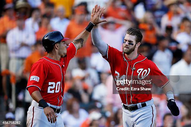 Bryce Harper and Ian Desmond of the Washington Nationals celebrate after they scored in the seventh inning against the San Francisco Giants during...