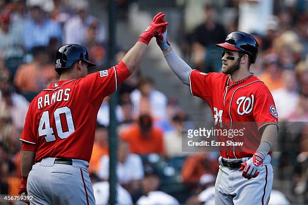 Bryce Harper of the Washington Nationals celebrates with Wilson Ramos after hitting a solo home run in the ninth inning against the San Francisco...