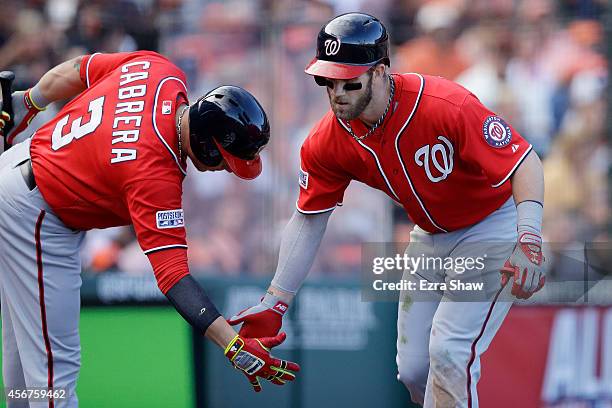 Bryce Harper of the Washington Nationals celebrates with Asdrubal Cabrera after hitting a solo home run in the ninth inning against the San Francisco...