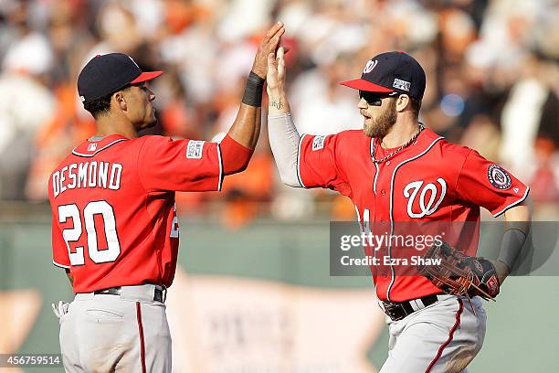 Bryce Harper celebrates with Ian Desmond of the Washington Nationals after their 4 to 1 win over the San Francisco Giants during Game Three of the...