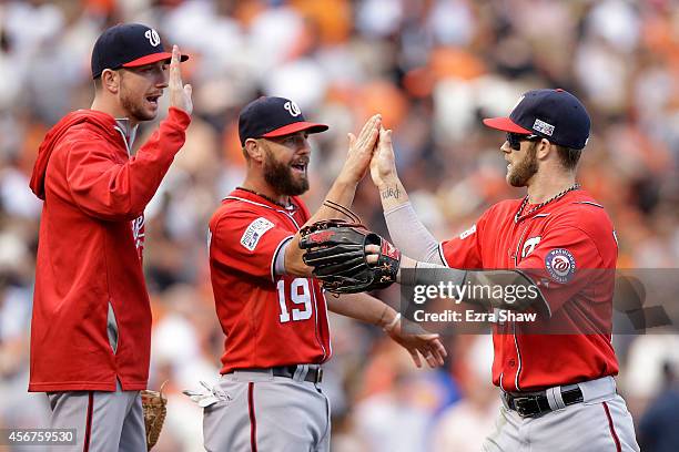 Bryce Harper celebrates with Kevin Frandsen of the Washington Nationals after their 4 to 1 win over the San Francisco Giants during Game Three of the...