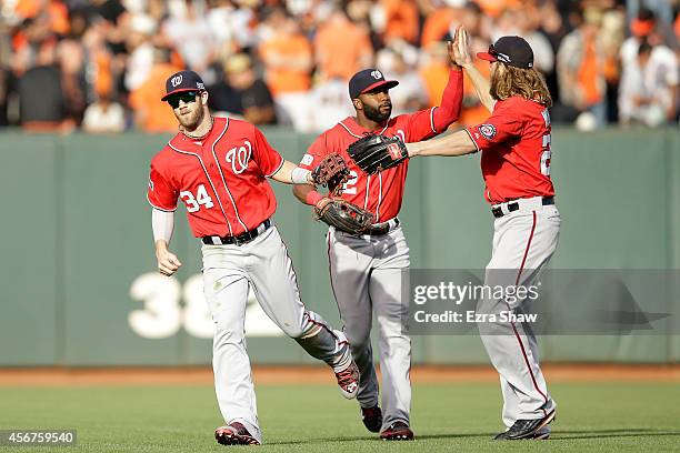 Bryce Harper celebrates with Denard Span and Jayson Werth of the Washington Nationals after their 4 to 1 win over the San Francisco Giants during...