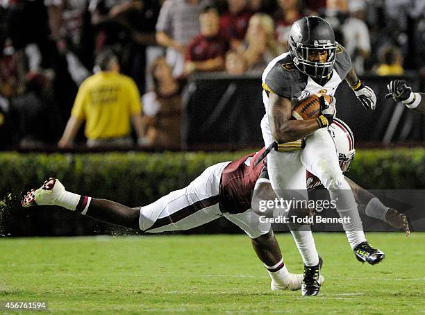 Tailback Marcus Murphy of the Missouri Tigers avoids a tackle by linebacker Skai Moore of the South Carolina Gamecocks during the fourth quarter on...