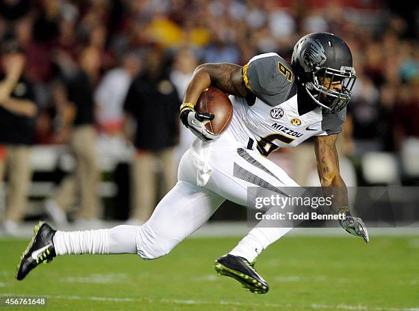 Tailback Marcus Murphy of the Missouri Tigers tries to elude defenders from the South Carolina Gamecocks during the first quarter on September 27,...