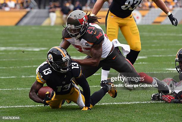 Safety Mark Barron of the Tampa Bay Buccaneers tackles running back Dri Archer of the Pittsburgh Steelers during a game at Heinz Field on September...