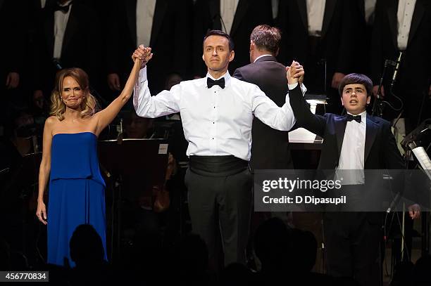 Kristin Chenoweth, Andrew Lippa, and Noah Marlowe take their curtain call during the "I Am Harvey Milk" Benefit Concert at Avery Fisher Hall, Lincoln...