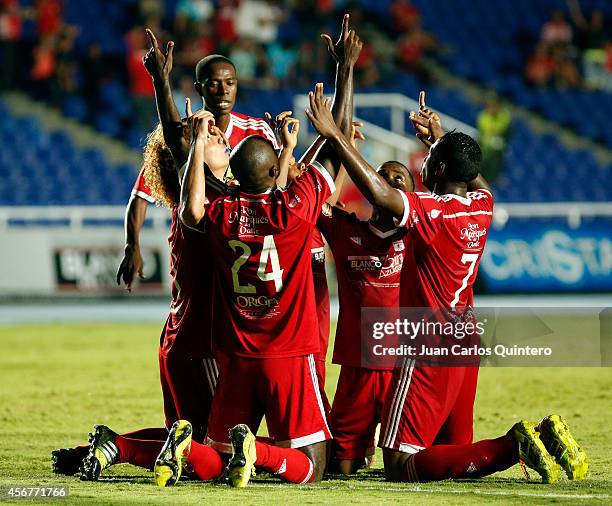 Players of America de Cali celebrate the first goal of his team scored goal by Oswaldo Blanco during a match between America de Cali and Santander as...