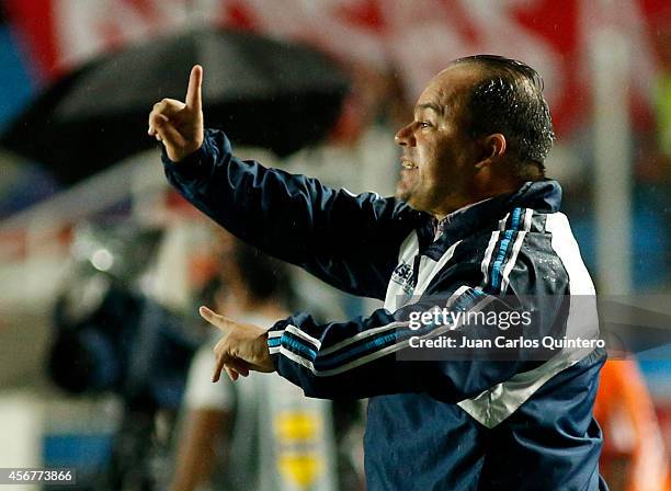 Head coach Víctor González of Santander gives directions to his players during a match between America de Cali and Santander as part of 14th round of...