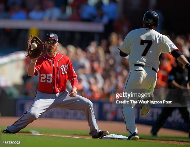 Washington first baseman Adam LaRoche , left, takes throw from Fister to put out San Francisco center fielder Gregor Blanco at first base in the 1st...