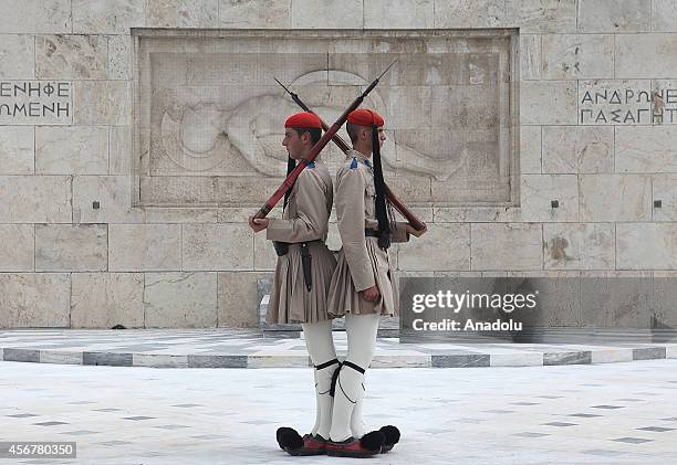 Evzone soldiers march outside Greek parliament and the Tomb of the Unknown Soldier during the change of guard in Athens, Greece on October 6, 2014....