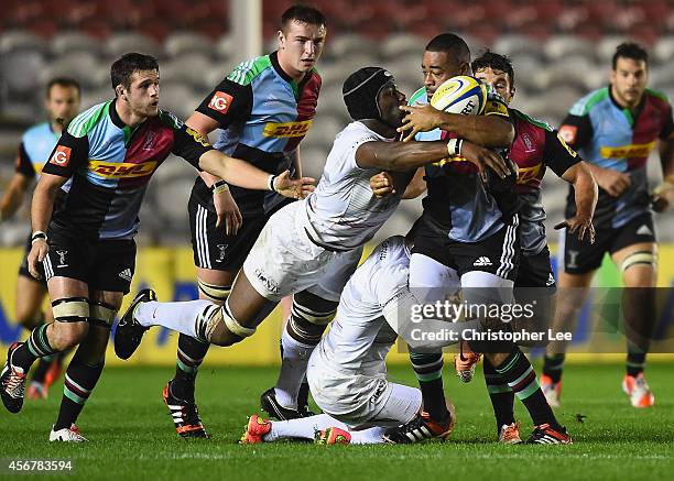 Darryl Marfo of Harlequins is tackled by Ben Spencer and Maro Itoje of Saracens during the Premiership A League match between Harlequins A and...