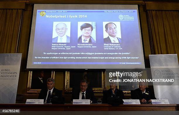 Giant screen displays the images of Japanese-born researchers Isamu Akasaki, Hiroshi Amano and Shuji Nakamura as Nobel Committee for Physics chairman...