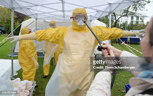 Volunteer doctor who will travel to West Africa to help care for Ebola patients is disinfectet during training offered by the German Red Cross on...