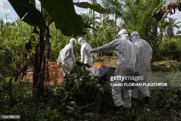 Specialized Ebola inhumation team carry the body of a recent Ebola victim to be buried, on October 6, 2014 in Magbonkoh. Ebola may only be present in...