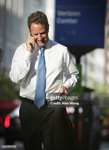 Former U.S. Secretary of the Treasury Timothy Geithner talks on his cell phone as he arrives at U.S. Court of Federal Claims to testify at the AIG...