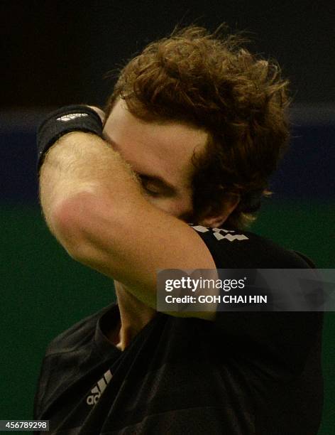 Andy Murray of Britain wipes his face after returning a shot against Teymuraz Gabashvili of Russia in the men's singles first round match at the...