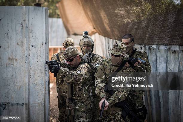 Israeli Airsoft teams in action during a combat simulation session, on October 7, 2014 in Kfar Saba, Israel. Originating in Japan, Airsoft is similar...