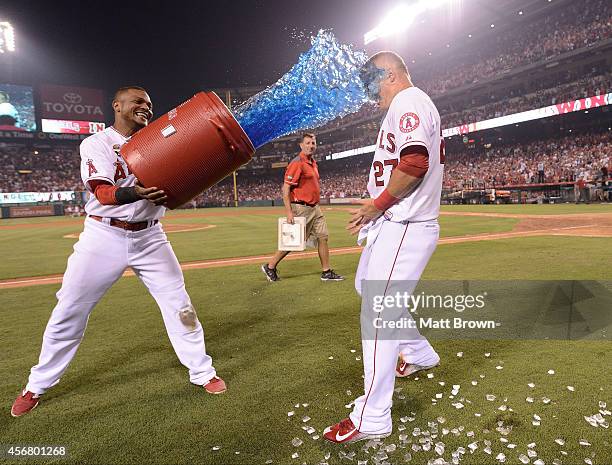 Erick Aybar of the Los Angeles Angels of Anaheim dumps Gatorade on teammate Mike Trout after the game against the Houston Astros on July 4, 2014 at...