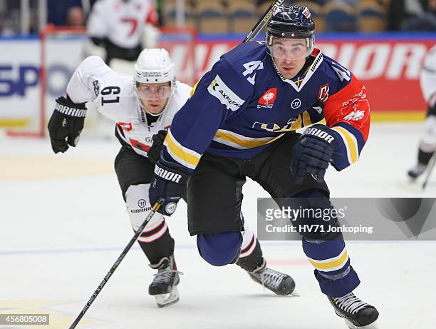 Juuso Ikonen of JYP Jyvaskyla chases Chris Campoli of HV71 during the Champions Hockey League group stage game between HV71 Jonkoping and JYP...