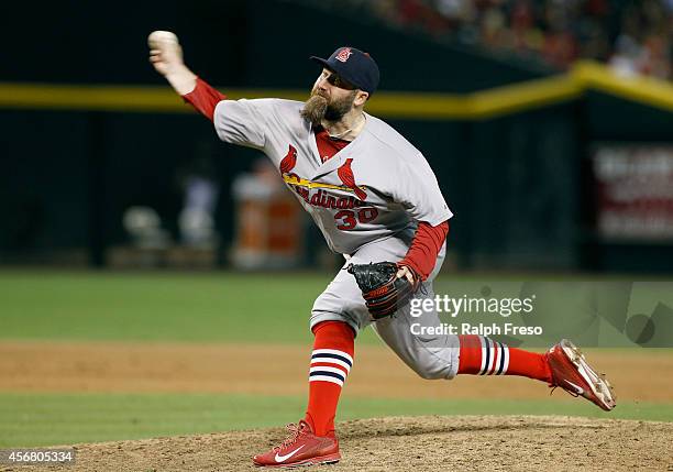 Jason Motte of the St Louis Cardinals delivers a pitch against the Arizona Diamondbacks during the eighth inning of a MLB game at Chase Field on...