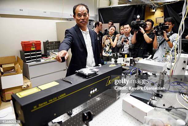 Santa Barbara scientist Shuji Nakamura points to a laser during a tour of the lab after winning the 2014 Nobel Prize for physics for invention of...
