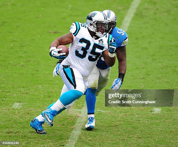 Mike Tolbert of the Carolina Panthers carries the ball against Stephen Tulloch of the Detroit Lions at Bank of America Stadium on September 14, 2014...