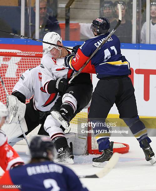 Chris Campoli of HV71 crosschecks < player from JYP Jyvaskyla during the Champions Hockey League group stage game between HV71 Jonkoping and JYP...