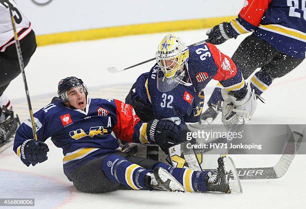 Chris Campoli of HV71 collides with Gustaf Wesslau Goaltender of HV71 during the Champions Hockey League group stage game between HV71 Jonkoping and...