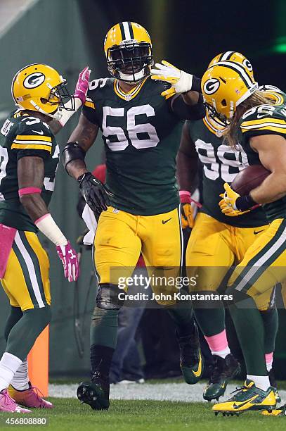 Julius Peppers of the Green Bay Packers celebrates with Sam Shields, Letroy Guion, and Clay Matthews after scoring against the Minnesota Vikings on...