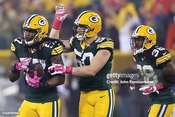 Jamari Lattimore of the Green Bay Packers celebrates his interception with A.J. Hawk during the second quarter of the NFL game against the Minnesota...