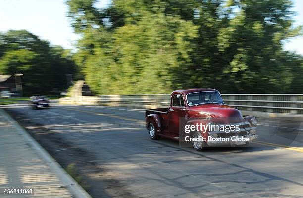 An old American-made pickup truck makes its way over a bridge over an affluent of the Connecticut River in Greenfield, Mass. Greenfield is part of...