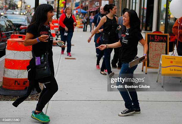 President of the Board of East Somerville Main Streets Renee Polcaro, left, and Foodie Crawl Chair Evelyn Yamauchi, right, dance to Radio Mambo as...