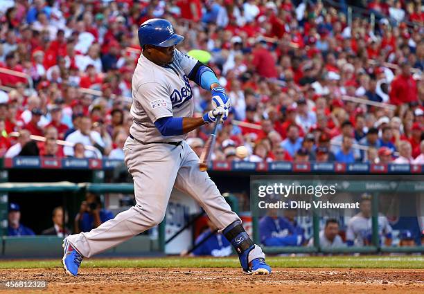 Juan Uribe of the Los Angeles Dodgers hits an RBI single in the sixth inning against the St. Louis Cardinals in Game Four of the National League...