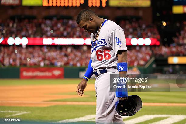 Yasiel Puig of the Los Angeles Dodgers walks off the field after being defeated by the St. Louis Cardinals in Game Four of the National League...