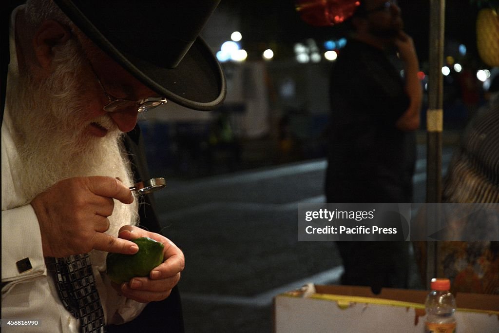 An Orthodox man checks for any blemishes during the annual...