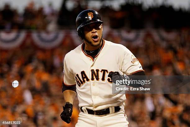 Gregor Blanco of the San Francisco Giants reacts after he is walked, scoring Brandon Crawford during Game Four of the National League Division Series...