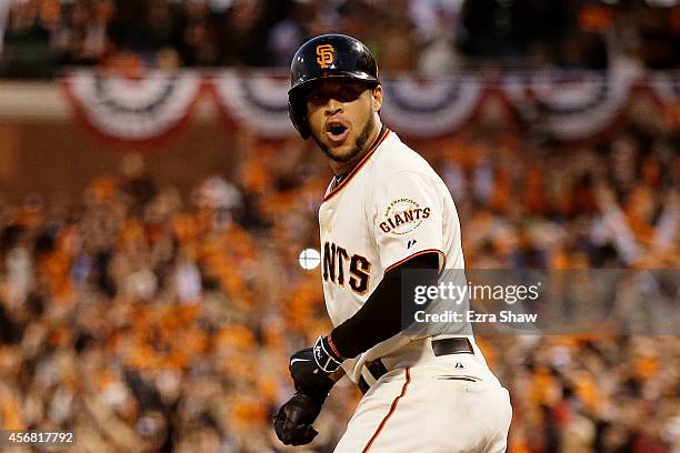 Gregor Blanco of the San Francisco Giants reacts after he is walked, scoring Brandon Crawford during Game Four of the National League Division Series...