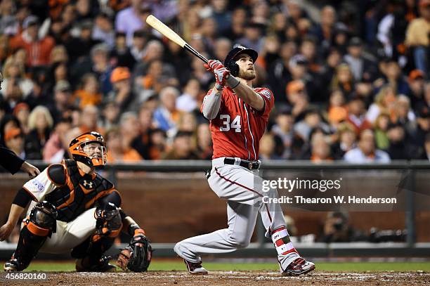 Bryce Harper of the Washington Nationals hits a solo home run in the seventh inning against the San Francisco Giants during Game Four of the National...