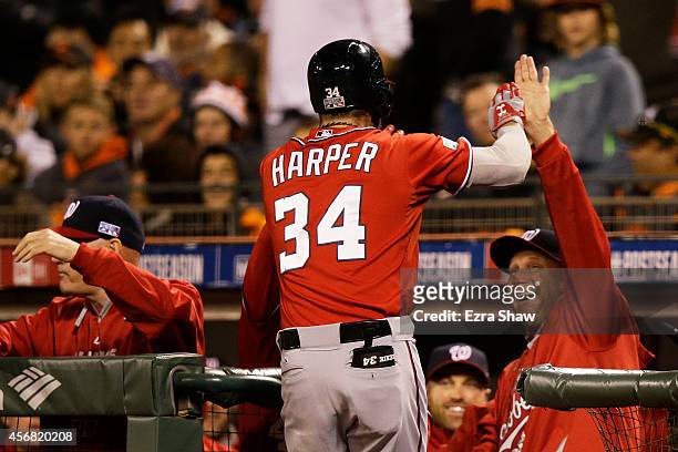 Bryce Harper of the Washington Nationals celebrates his solo home run with manager Matt Williams in the seventh inning against the San Francisco...