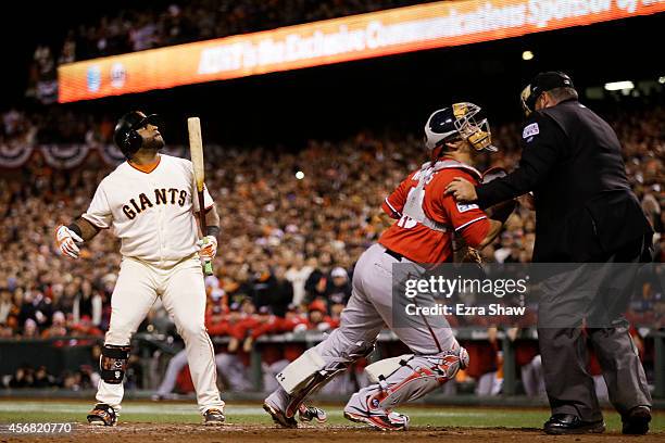 Pablo Sandoval of the San Francisco Giants looks on as Wilson Ramos of the Washington Nationals tries to recover a wild pitch that scored Joe Panik...